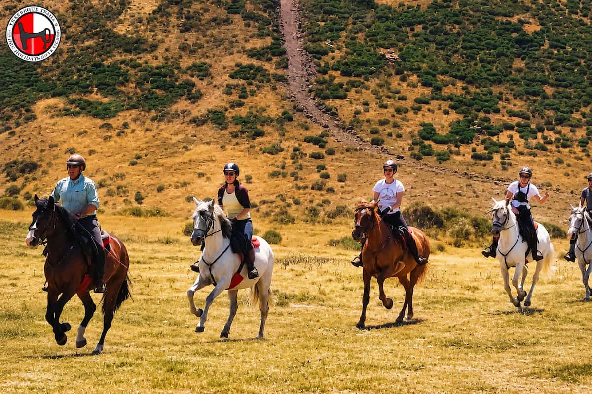 Mountain horse riding holidays climbing a granite track in the Sierra de Gredos.